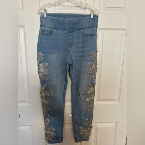 Light blue jeggings with silver stitching & crystals down the outside of legs.